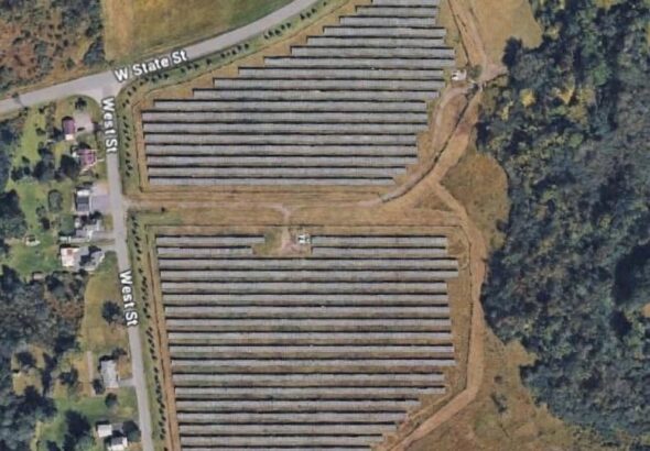 Google Earth satellite view showing solar panels installed on rural property associated with New York Assemblyman Robert Smullen in upstate New York.