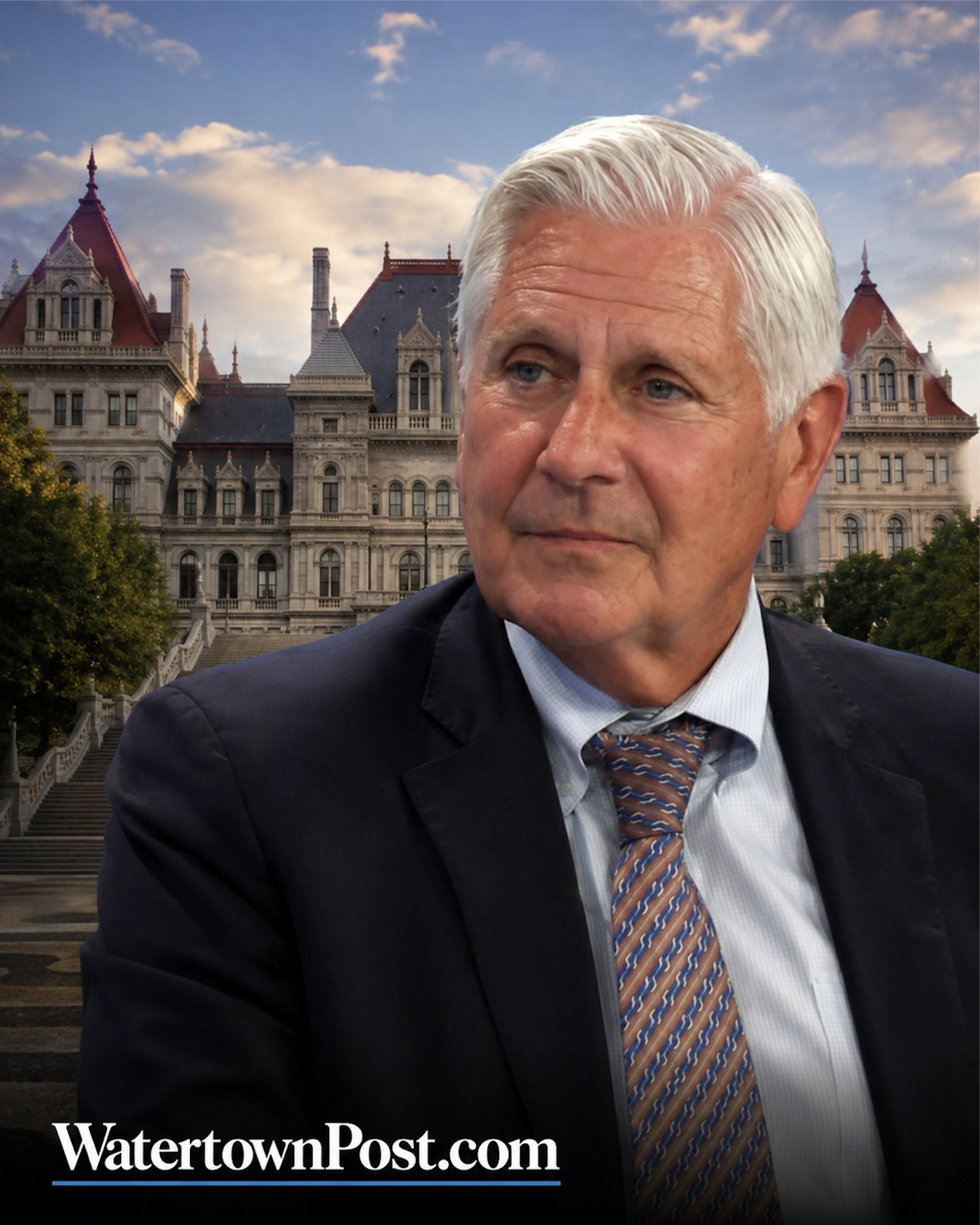 Bruce Blakeman in a suit posed before the New York State Capitol in Albany with WatertownPost.com branding at the bottom.
