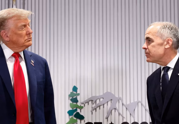 President Donald Trump speaks with Canadian Prime Minister Mark Carney during a meeting.