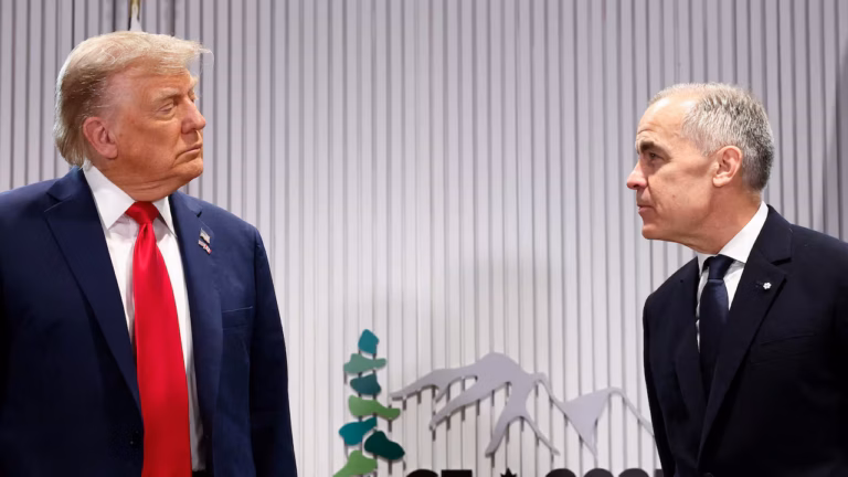 President Donald Trump speaks with Canadian Prime Minister Mark Carney during a meeting.