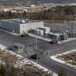 Conceptual aerial view of a compact nuclear microreactor facility enclosed by security fencing at Fort Drum in Northern New York.