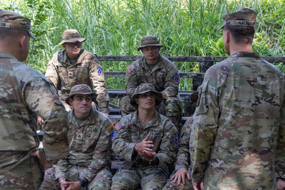 Seated 10th Mountain Division soldiers listen to Maj. Gen. Scott Naumann before a jungle-course graduation in Panama.