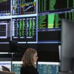 Control-room operators and monitoring screens at Ontario’s Independent Electricity System Operator.