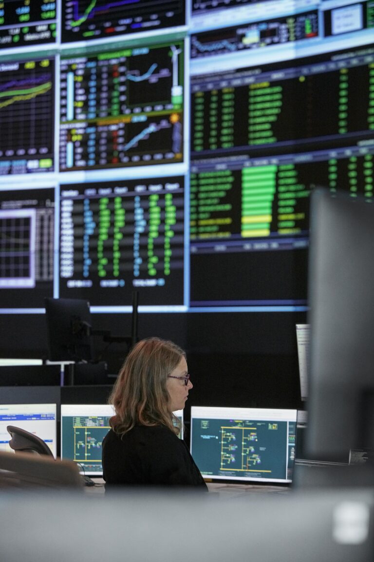 Control-room operators and monitoring screens at Ontario’s Independent Electricity System Operator.
