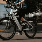 A rider on a white electric bicycle on a street, in a stock photograph by KBO Bike.