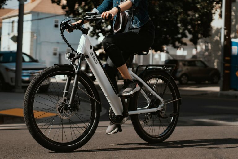 A rider on a white electric bicycle on a street, in a stock photograph by KBO Bike.
