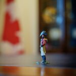 Red-coated figurine of Major-General Sir Isaac Brock on Mark Carney’s desk, with a blurred Canadian flag behind it.