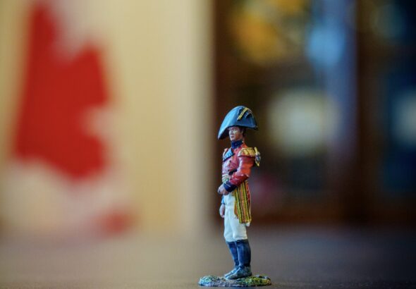 Red-coated figurine of Major-General Sir Isaac Brock on Mark Carney’s desk, with a blurred Canadian flag behind it.