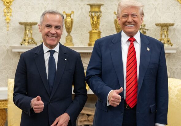 Mark Carney and Donald Trump smile and give thumbs-up while standing together in the Oval Office.